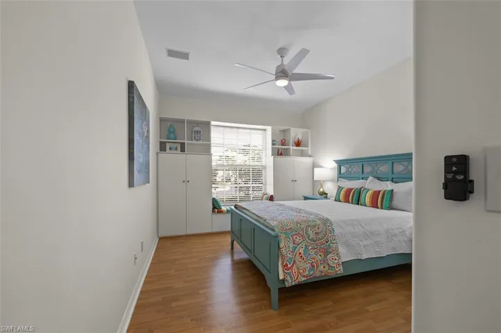 Bedroom featuring ceiling fan and hardwood / wood-style flooring