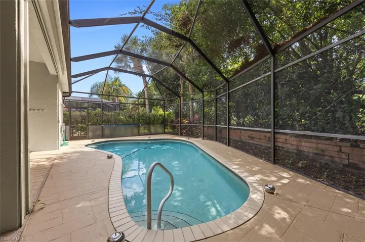 View of swimming pool with a patio and a lanai