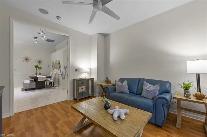 Living room featuring ceiling fan and light wood-type flooring