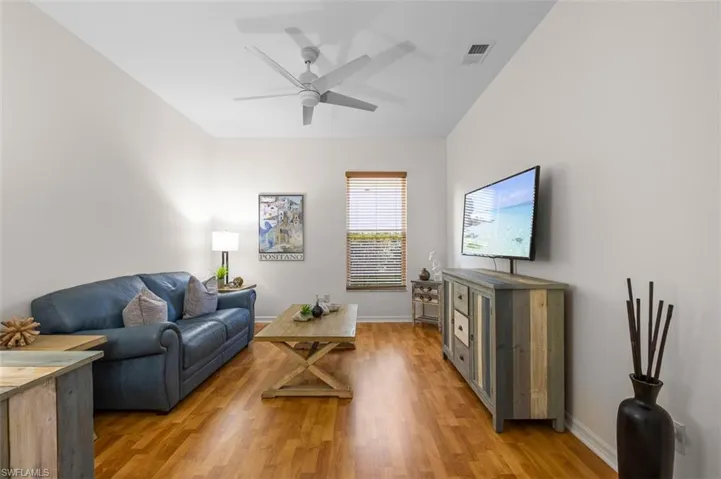 Living room featuring ceiling fan and hardwood / wood-style flooring