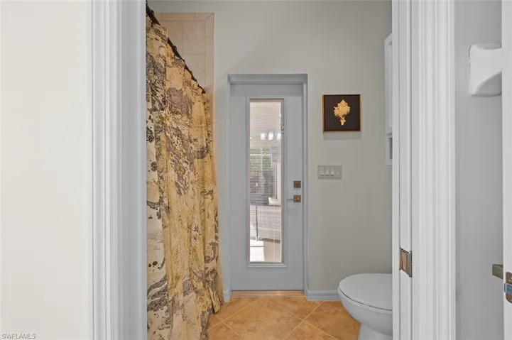 Bathroom with plenty of natural light, tile patterned flooring, and toilet