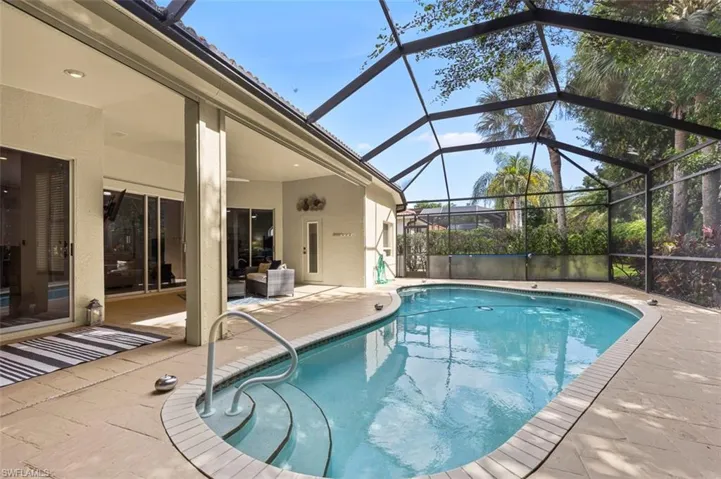 View of swimming pool with a patio area and a lanai