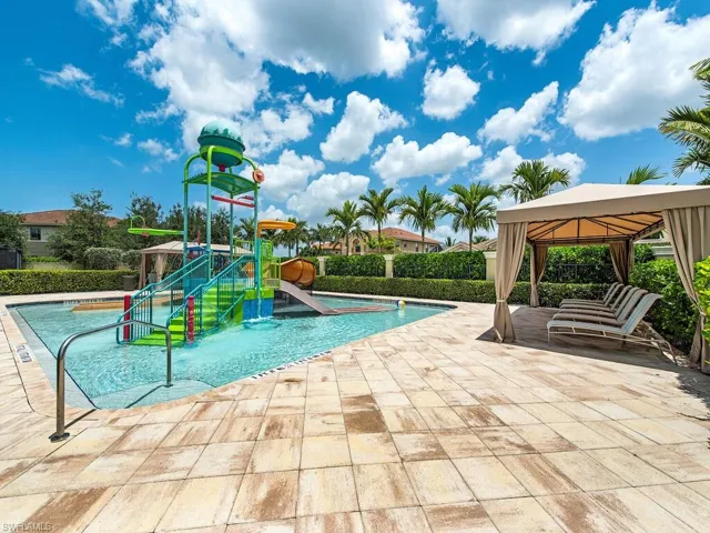 View of pool with a gazebo, a patio area, a playground, and a water slide