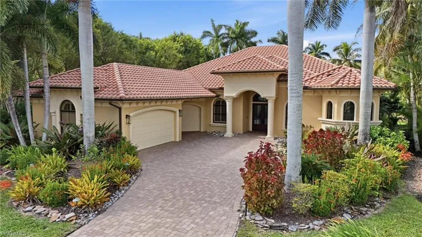Mediterranean / spanish-style home featuring stucco siding, a garage, a tiled roof, and decorative driveway