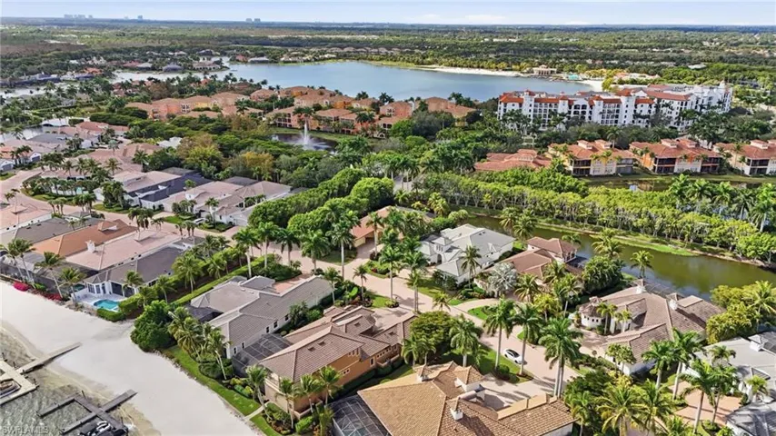 Aerial view of property and surrounding area with a large body of water and nearby suburban area