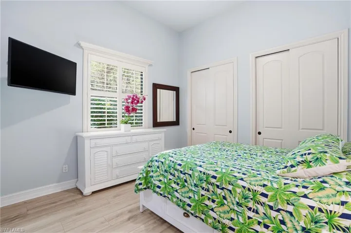 Bedroom featuring two closets and light wood finished floors