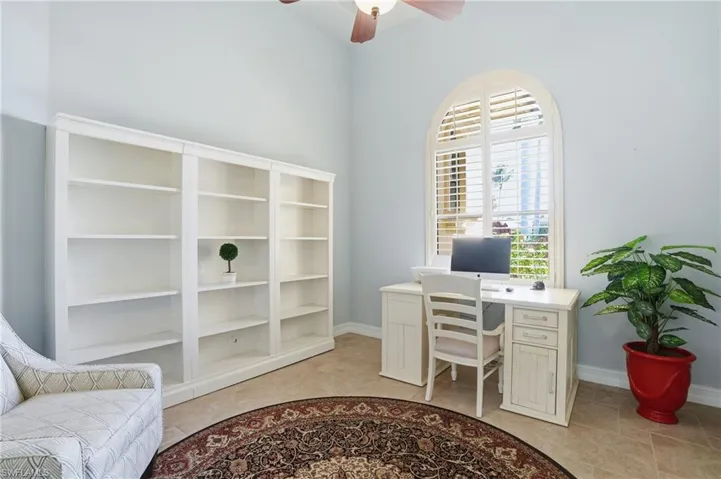 Office area featuring a ceiling fan and baseboards