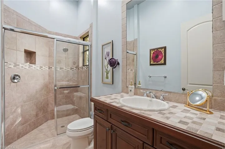 Bathroom featuring vanity and a stall shower