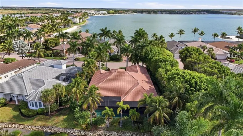 Aerial view of residential area featuring a nearby body of water