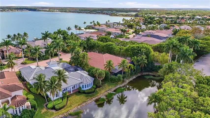 Aerial perspective of suburban area featuring a nearby body of water