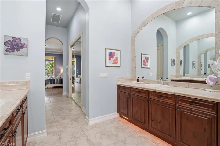 Ensuite bathroom featuring vanity and baseboards