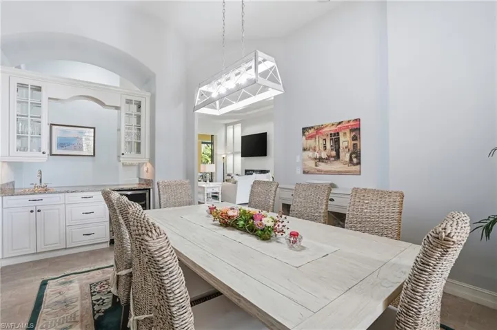 Dining room with a towering ceiling and light tile patterned floors