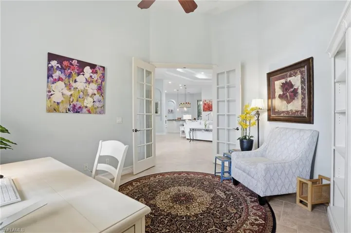 Office area featuring french doors, a high ceiling, and ceiling fan