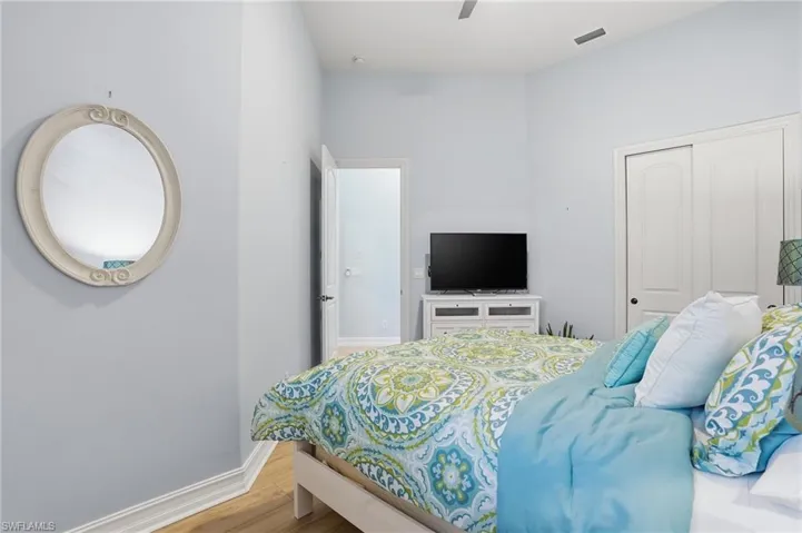 Bedroom featuring wood finished floors, a closet, and ceiling fan