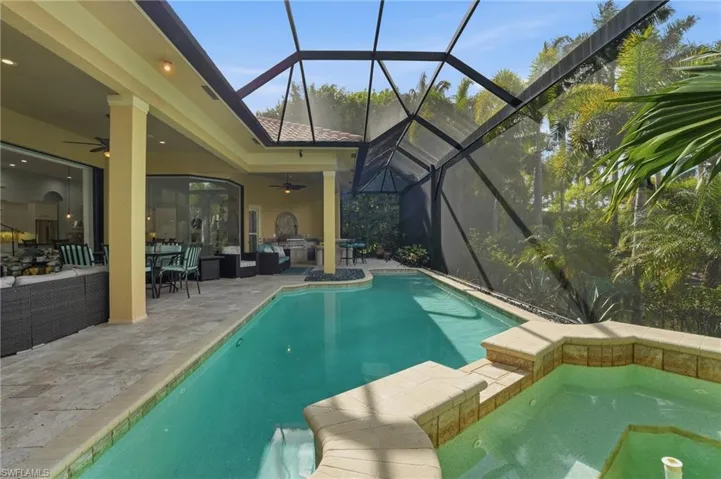 View of pool with a sunroom, an outdoor living space, a patio area, outdoor dining area, and a lanai