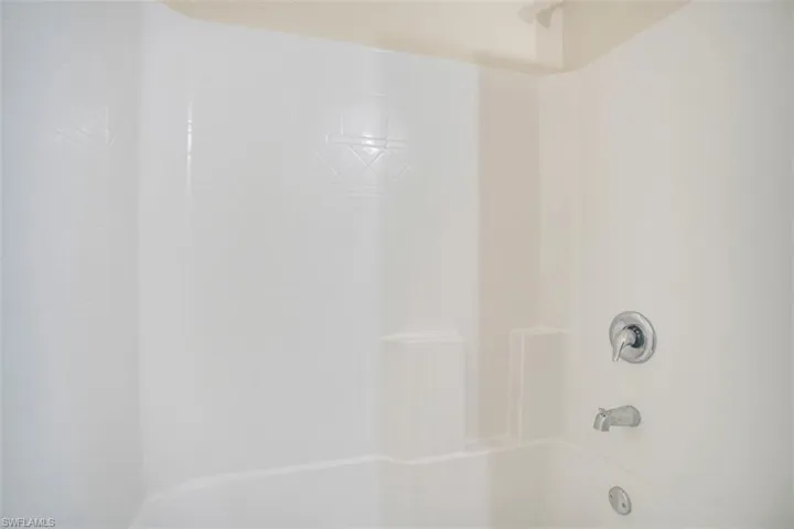 Interior details with tiled shower / bath combo
