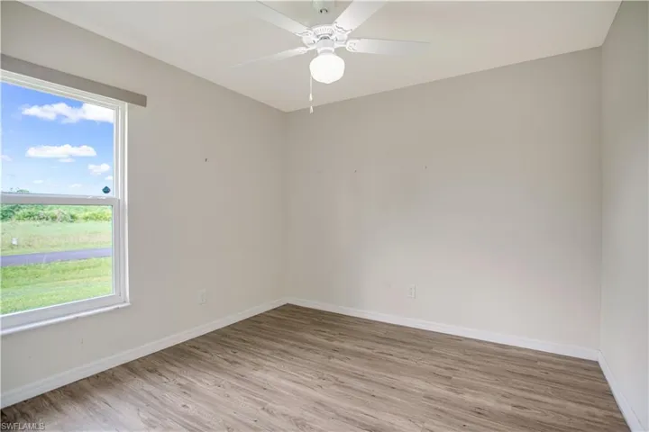 Bedroom with ceiling fan and ample closet space