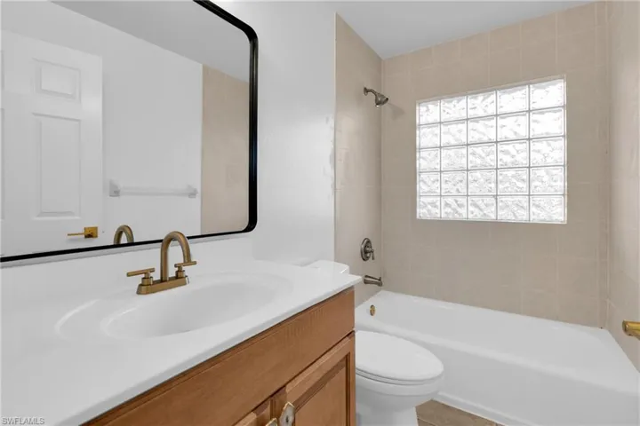 Bathroom with vanity and tub / shower combination