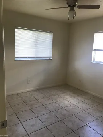Rear bedroom-tiled with lighted ceiling fan