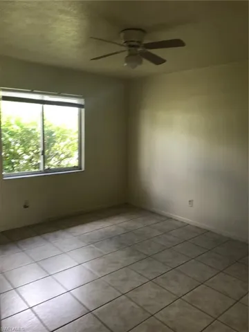 Front bedroom-tiled floor and lighted ceiling fan