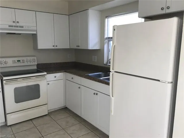 Kitchen overlooks rear yard and has an interior laundry closet