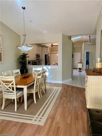 Dining area featuring vaulted ceiling and light wood-type flooring
