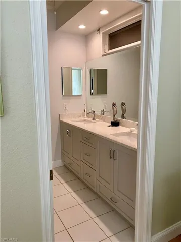 Bathroom with tile patterned flooring and vanity