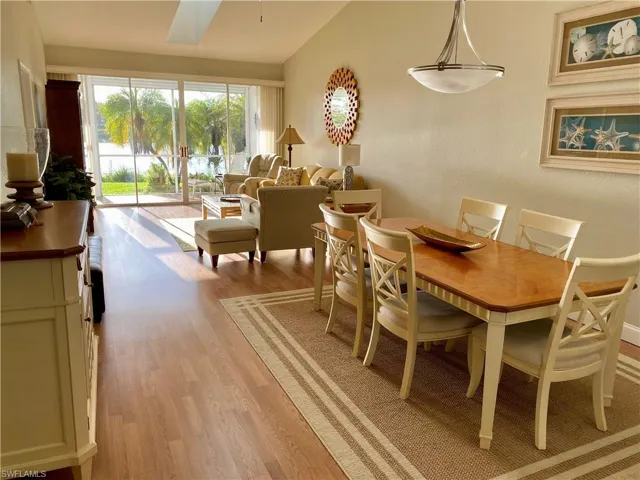 Dining space featuring light wood-type flooring and lofted ceiling
