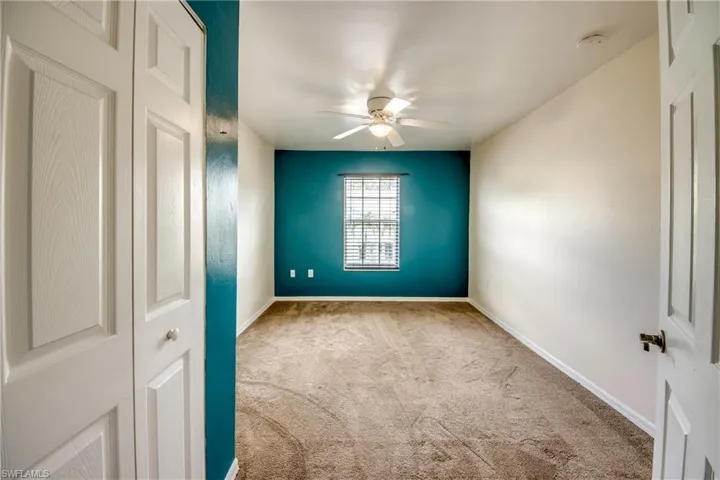 Unfurnished room with carpet and ceiling fan