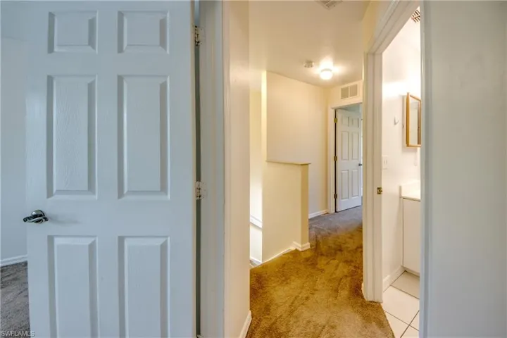 Hall featuring light tile flooring