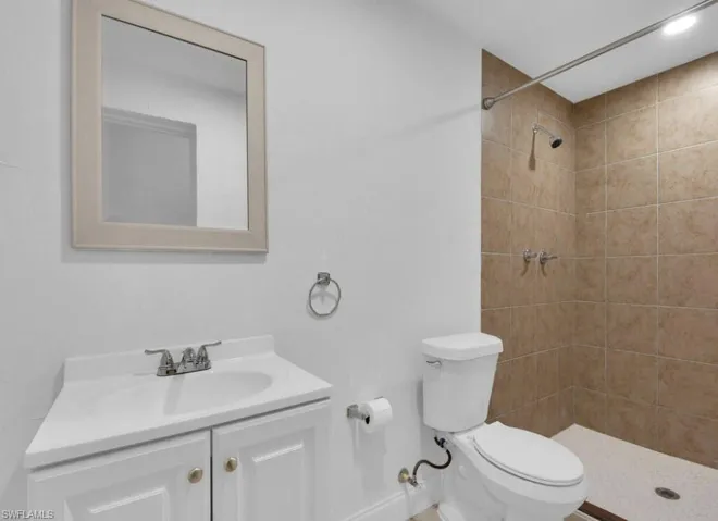 Full bathroom featuring vanity and a shower stall
