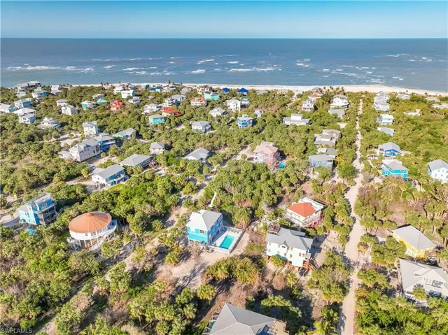 Birds eye view of property with a water view