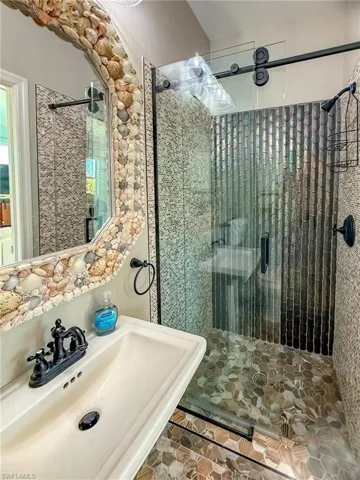 Full bathroom with a shower stall and a sink