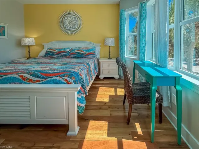 Bedroom featuring wood finished floors and baseboards