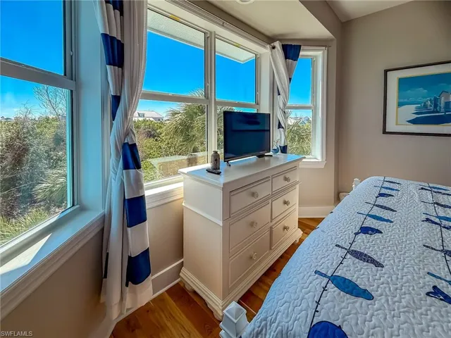 Bedroom with baseboards and wood finished floors