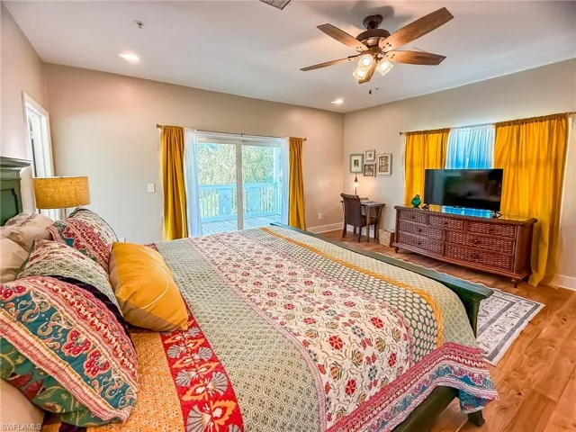 Bedroom with access to outside, wood finished floors, recessed lighting, baseboards, and ceiling fan