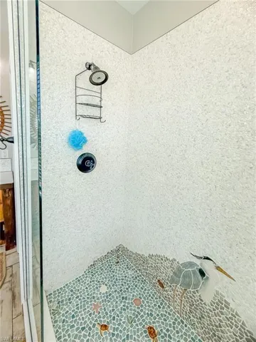 Full bathroom featuring a tile shower