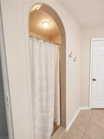 Primary bath features a walk-in shower with tiled surround.