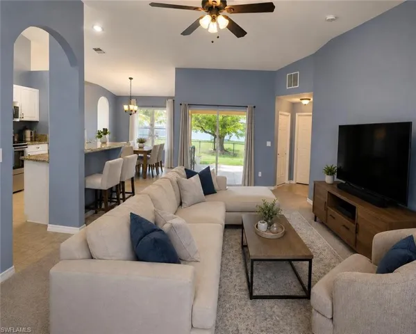 Open-concept great room with vaulted ceilings and views of the backyard.