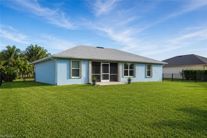 Spacious backyard with a screened lanai and room to relax, play, or entertain.