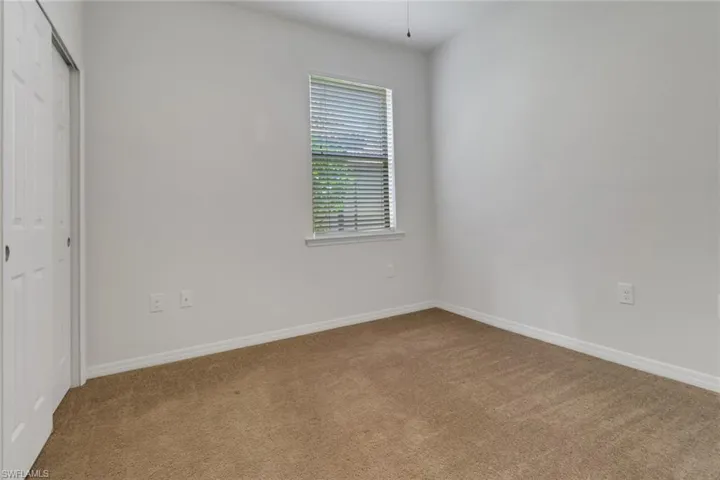 Unfurnished bedroom with carpet flooring and a closet