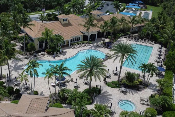 Community pool with a hot tub and a patio area