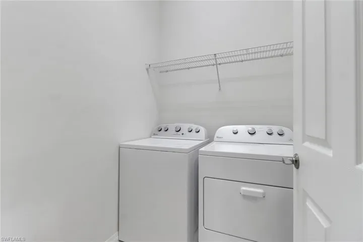 Washroom with washing machine and clothes dryer