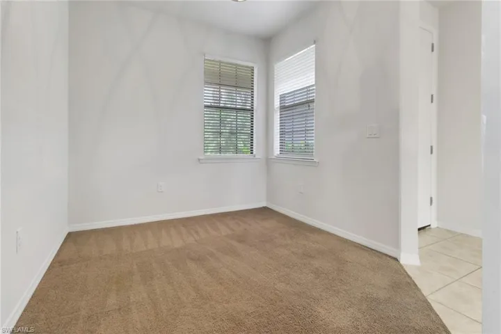 Empty room featuring light carpet