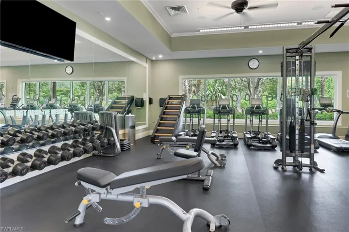 Exercise room featuring ceiling fan, ornamental molding, and recessed lighting