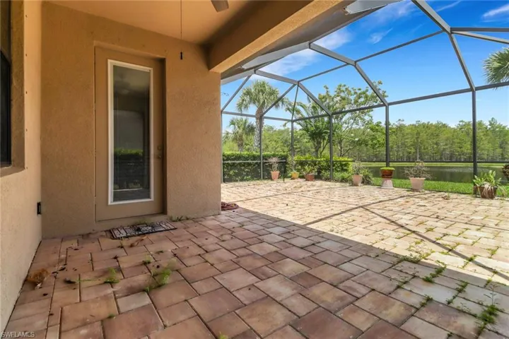View of patio featuring a lanai and a ceiling fan
