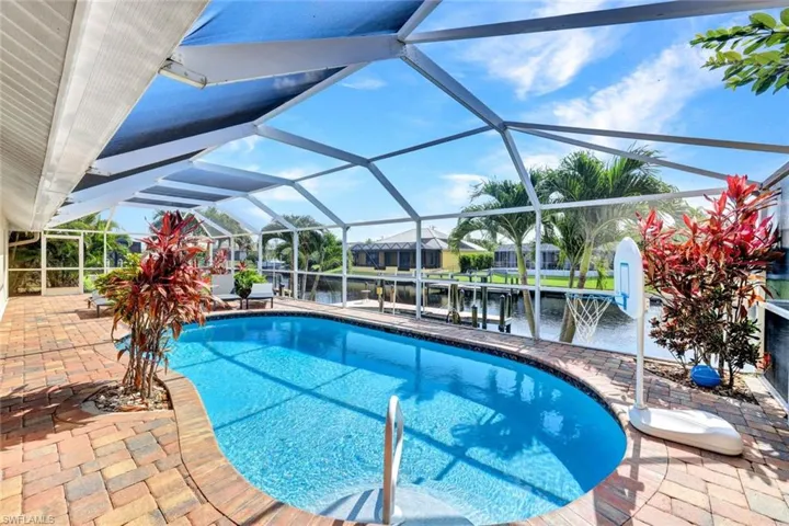 View of pool featuring a patio area and a lanai