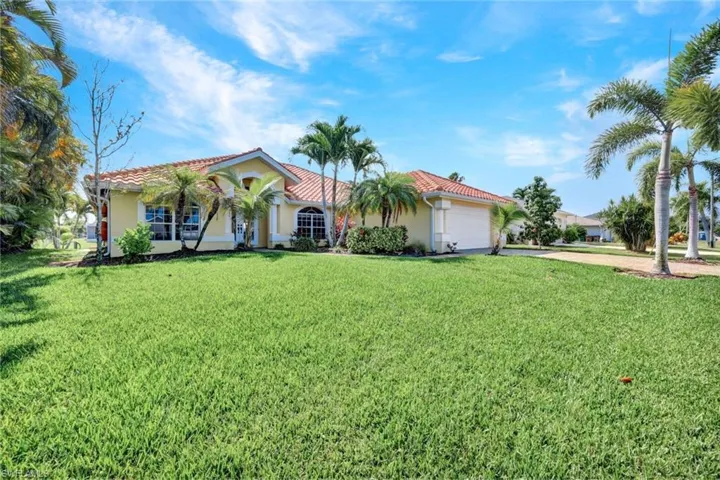 Mediterranean / spanish house with a garage and a front lawn