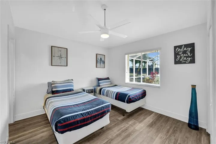 Bedroom with ceiling fan and hardwood / wood-style floors
