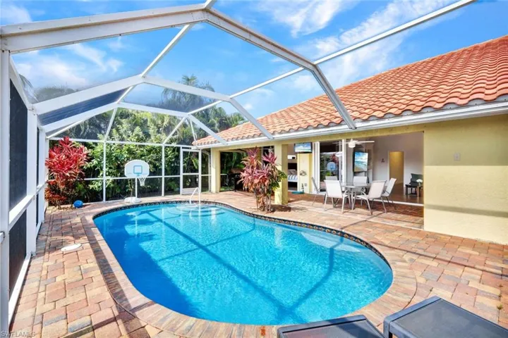 View of pool with a patio and a lanai